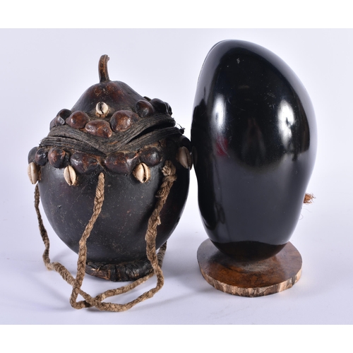 369 - AN AFRICAN TRIBAL SHELL MOUNTED BOX AND COVER together with a coco de mer. Largest 21 cm high. (2)