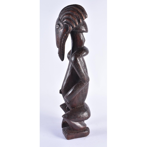 373 - AN UNUSUAL AFRICAN TRIBAL CARVED WOOD FIGURE inlaid with shell eyes. 44 cm high.