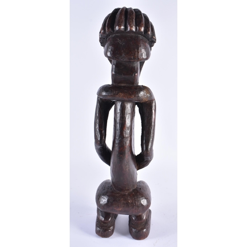 373 - AN UNUSUAL AFRICAN TRIBAL CARVED WOOD FIGURE inlaid with shell eyes. 44 cm high.