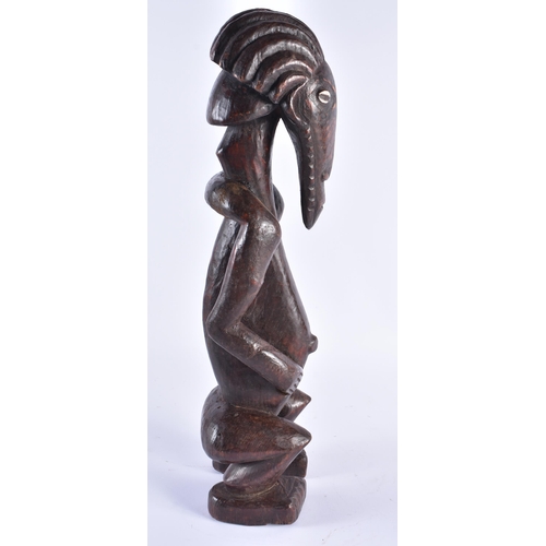 373 - AN UNUSUAL AFRICAN TRIBAL CARVED WOOD FIGURE inlaid with shell eyes. 44 cm high.