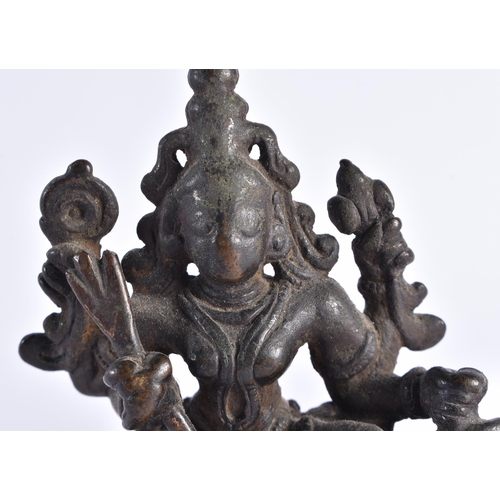 377 - AN 18TH CENTURY INDIAIN BRONZE FIGURE OF A DEITY modelled standing upon a beast. 12 cm x 7 cm.