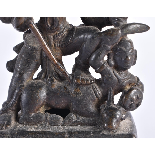 377 - AN 18TH CENTURY INDIAIN BRONZE FIGURE OF A DEITY modelled standing upon a beast. 12 cm x 7 cm.