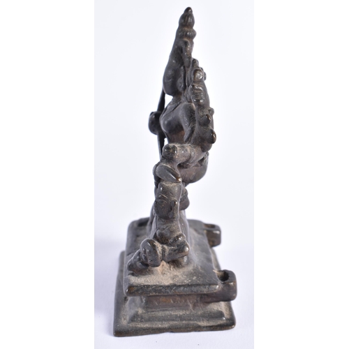 377 - AN 18TH CENTURY INDIAIN BRONZE FIGURE OF A DEITY modelled standing upon a beast. 12 cm x 7 cm.