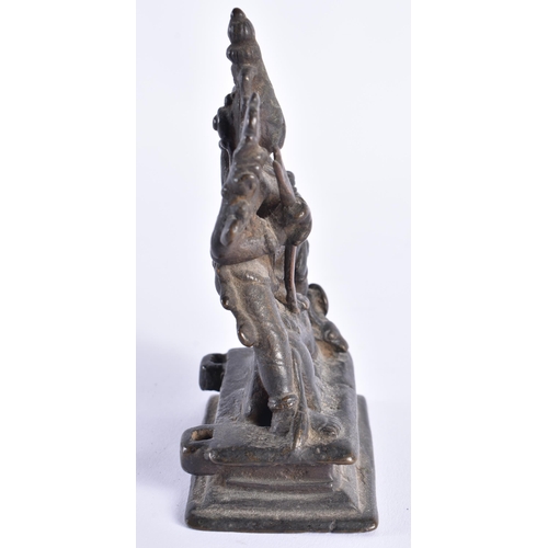 377 - AN 18TH CENTURY INDIAIN BRONZE FIGURE OF A DEITY modelled standing upon a beast. 12 cm x 7 cm.