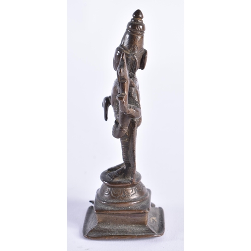 378 - AN 18TH CENTURY INDIAIN BRONZE FIGURE OF A DEITY modelled standing with one hand downturned. 11 cm h... 