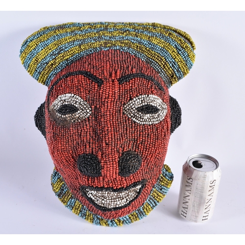 381 - AN AFRICAN BEADWORK CARVED WOOD MASK. 34 cm x 28 cm.