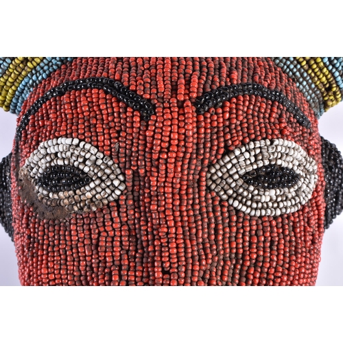 381 - AN AFRICAN BEADWORK CARVED WOOD MASK. 34 cm x 28 cm.