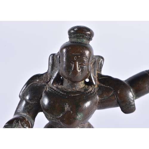 385 - AN 18TH CENTURY INDIAN BRONZE FIGURE OF A HINDU DEITY modelled with one side arm raised. 11 cm high.