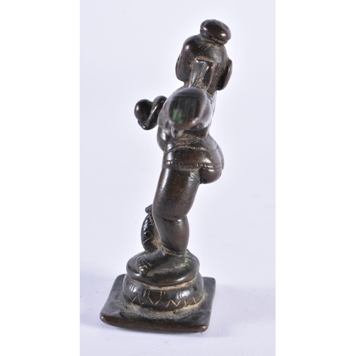 385 - AN 18TH CENTURY INDIAN BRONZE FIGURE OF A HINDU DEITY modelled with one side arm raised. 11 cm high.