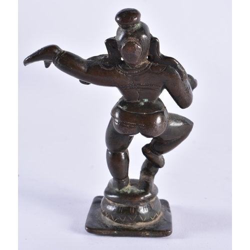 385 - AN 18TH CENTURY INDIAN BRONZE FIGURE OF A HINDU DEITY modelled with one side arm raised. 11 cm high.