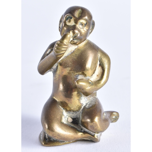 389 - A SMALL 19TH CENTURY BRONZE FIGURE OF A SEATED MONKEY possibly modelled taking snuff. 6 cm high.