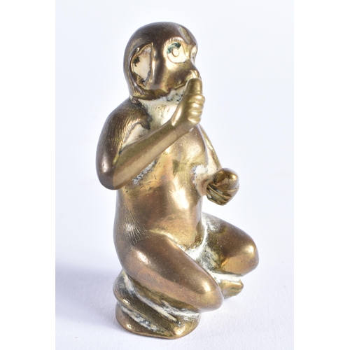 389 - A SMALL 19TH CENTURY BRONZE FIGURE OF A SEATED MONKEY possibly modelled taking snuff. 6 cm high.