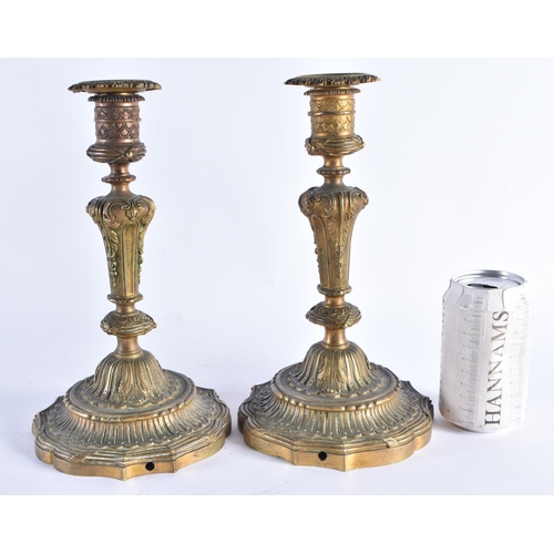 391 - A PAIR OF EARLY 19TH CENTURY FRENCH GILT BRONZE CANDLESTICKS formed with central scrolling acanthus ... 