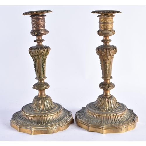 391 - A PAIR OF EARLY 19TH CENTURY FRENCH GILT BRONZE CANDLESTICKS formed with central scrolling acanthus ... 