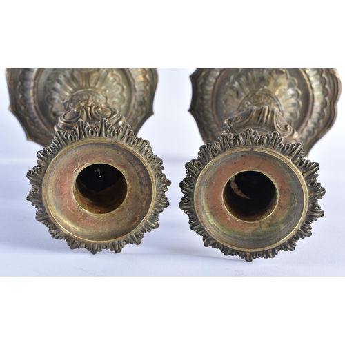 391 - A PAIR OF EARLY 19TH CENTURY FRENCH GILT BRONZE CANDLESTICKS formed with central scrolling acanthus ... 