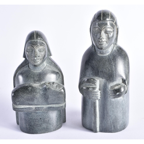 402 - TWO INUIT CARVED STONE FIGURES possibly representing nativity. Largest 15 cm high. (2)