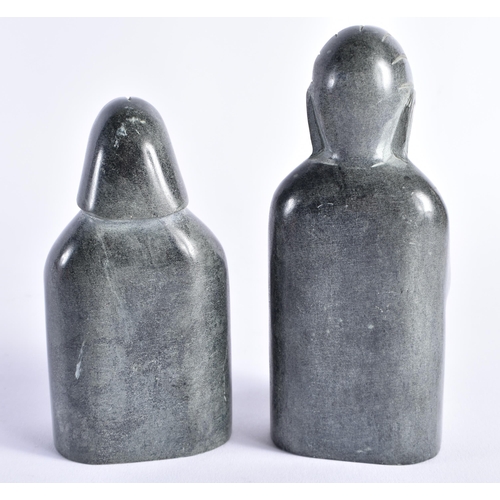 402 - TWO INUIT CARVED STONE FIGURES possibly representing nativity. Largest 15 cm high. (2)