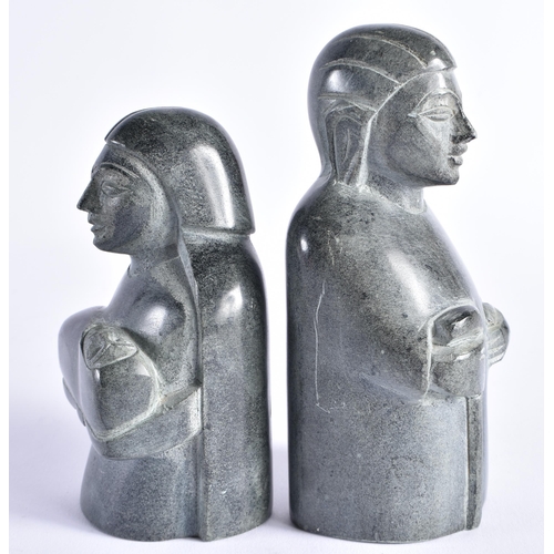 402 - TWO INUIT CARVED STONE FIGURES possibly representing nativity. Largest 15 cm high. (2)