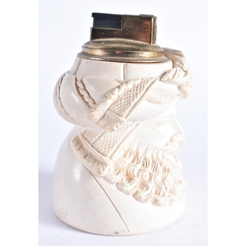 403 - AN UNUSUAL CARVED MEERSCHAUM TURKISH MAN TABLE LIGHTER together with an unusual sand glass oil lamp.... 