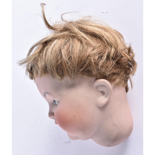 409 - AN UNUSUAL ANTIQUE GERMAN SIMON HALBIG MALE BISQUE PORCELAIN DOLL HEAD. 21 cm x 12 cm.