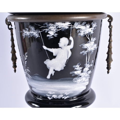 411 - A LARGE VICTORIAN ENAMELLED MARY GREGORY GLASS OIL LAMP depicting a girl upon a swing. 57 cm high.