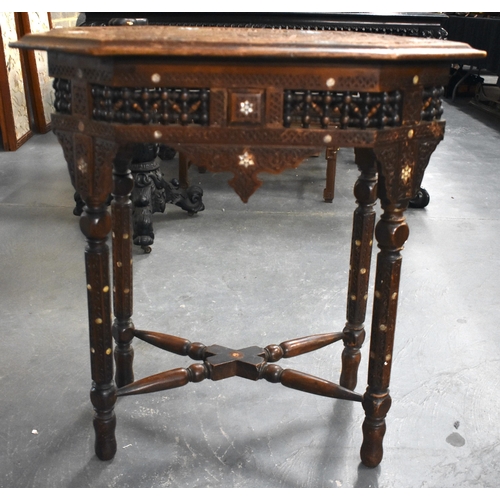 415 - A 19TH CENTURY MIDDLE EASTERN ISLAMIC CARVED WOOD TABLE decorated with calligraphy. 79cm x 75cm x 47... 