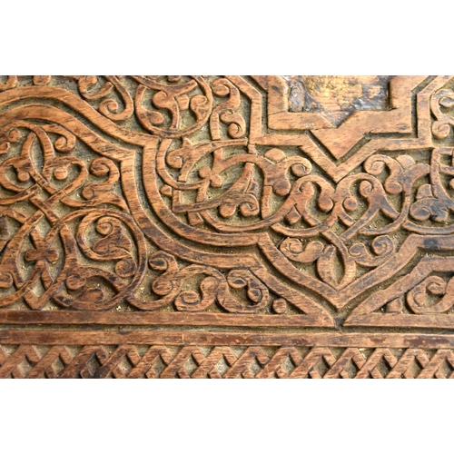 415 - A 19TH CENTURY MIDDLE EASTERN ISLAMIC CARVED WOOD TABLE decorated with calligraphy. 79cm x 75cm x 47... 