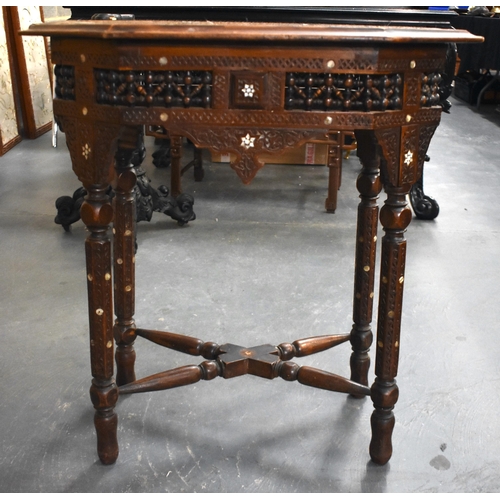 415 - A 19TH CENTURY MIDDLE EASTERN ISLAMIC CARVED WOOD TABLE decorated with calligraphy. 79cm x 75cm x 47... 