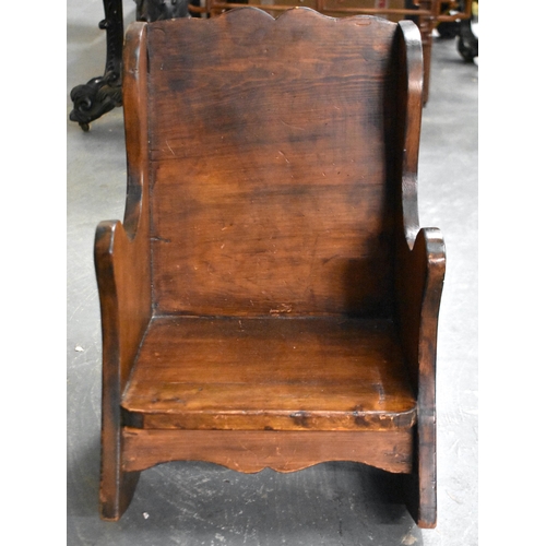 416 - A SMALL ANTIQUE ENGLISH CARVED WOOD CHILDS ROCKING CHAIR. 52.5 cm x 37.5 cm x 40cm