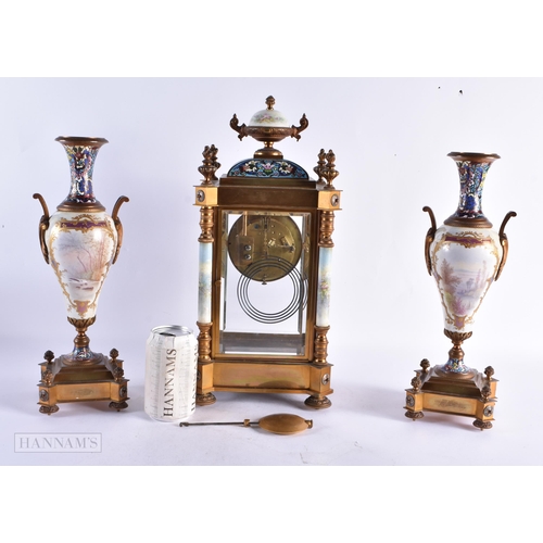 449 - A FINE 19TH CENTURY FRENCH CHAMPLEVE ENAMEL AND PORCELAIN REGUALTOR CLOCK GARNITURE painted with put... 