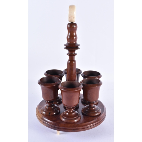 45 - AN EDWARDIAN MAHOGANY EGG SERVING STAND. 28 cm high.