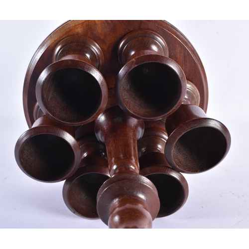 45 - AN EDWARDIAN MAHOGANY EGG SERVING STAND. 28 cm high.