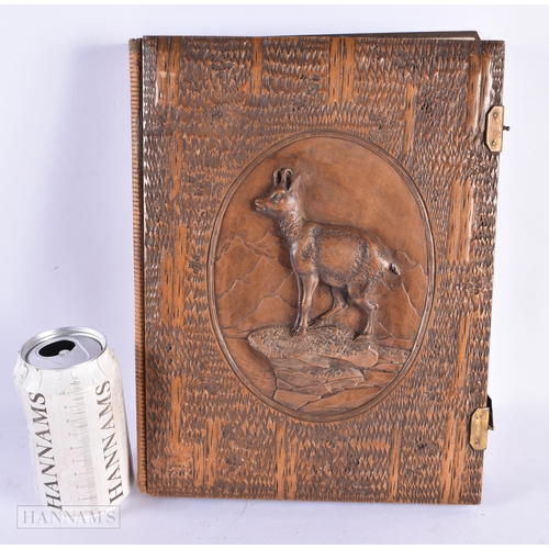 466 - AN UNUSUAL EARLY 20TH CENTURY SWISS BAVARIAN BLACK FOREST POSTCARD ALBUM formed in relief with a mou... 