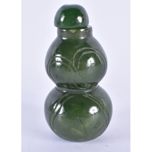 469 - A LATE 19TH CENTURY CHINESE CARVED SPINACH JADE SNUFF BOTTLE AND STOPPER Late Qing. 7.25 cm high.