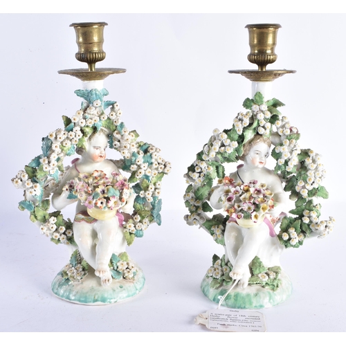 47 - A RARE PAIR OF 18TH CENTURY DERBY PORCELAIN CANDLESTICKS formed as figures holding baskets of flower... 