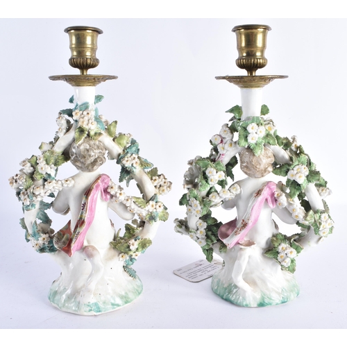 47 - A RARE PAIR OF 18TH CENTURY DERBY PORCELAIN CANDLESTICKS formed as figures holding baskets of flower... 