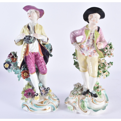 48 - A PAIR OF 18TH CENTURY DERBY PORCELAIN FIGURES modelled as figures upon foliage. 22 cm high.