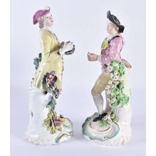 48 - A PAIR OF 18TH CENTURY DERBY PORCELAIN FIGURES modelled as figures upon foliage. 22 cm high.