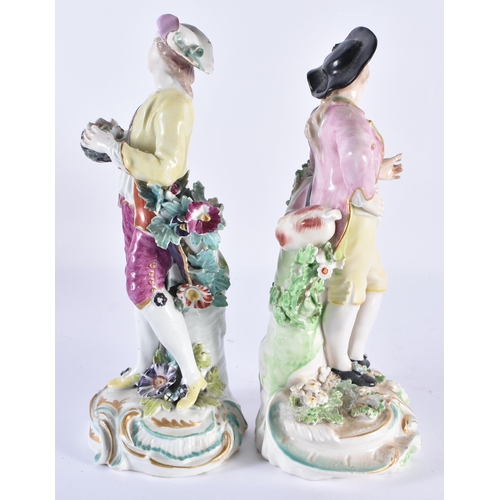 48 - A PAIR OF 18TH CENTURY DERBY PORCELAIN FIGURES modelled as figures upon foliage. 22 cm high.