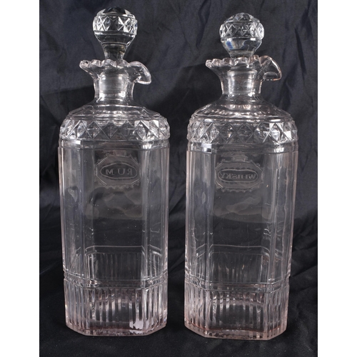 542 - A PAIR OF REGENCY CUT GLASS RUM AND WHISKEY DECANTERS. 22 cm high.