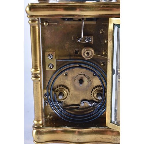 628 - AN ANTIQUE FRENCH ART NOUVEAU BRASS CARRIAGE CLOCK. 15 cm high inc handle.