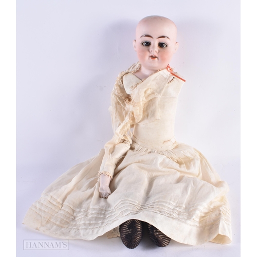 668 - A BISQUE HEADED DOLL. 57 cm long.