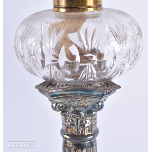 669 - A LARGE PAIR OF VICTORIAN SILVER PLATED OIL LAMPS. 57 cm high.