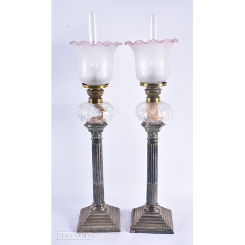 669 - A LARGE PAIR OF VICTORIAN SILVER PLATED OIL LAMPS. 57 cm high.