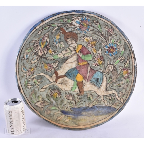 678 - A LARGE 19TH CENTURY PERSIAN QAJAR POTTERY TILE painted in relief with a figure on horseback. 40 cm ... 