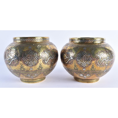 70 - A PAIR OF LATE 19TH CENTURY ISLAMIC MIDDLE EASTERN SILVER INLAID VASES decorated with scripture and ... 