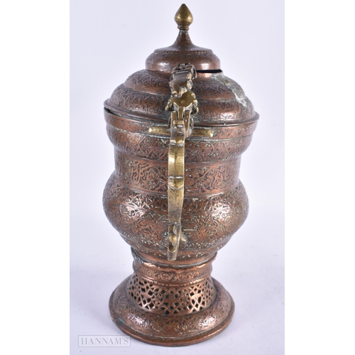 702 - AN ANTIQUE ISLAMC PERSIAN RETICULATED COPPER ALLOY EWER. 32 cm high.