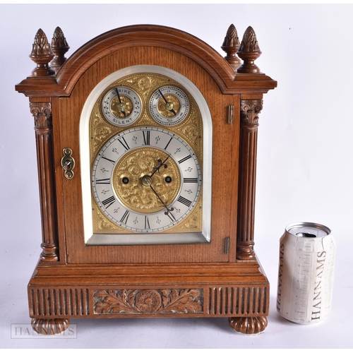 714 - AN ANTIQUE OAK BRACKET CLOCK with engraved foliate dial. 35 cm x 27 cm.