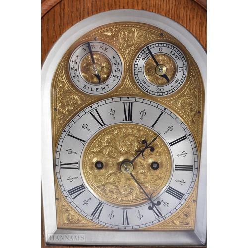 714 - AN ANTIQUE OAK BRACKET CLOCK with engraved foliate dial. 35 cm x 27 cm.