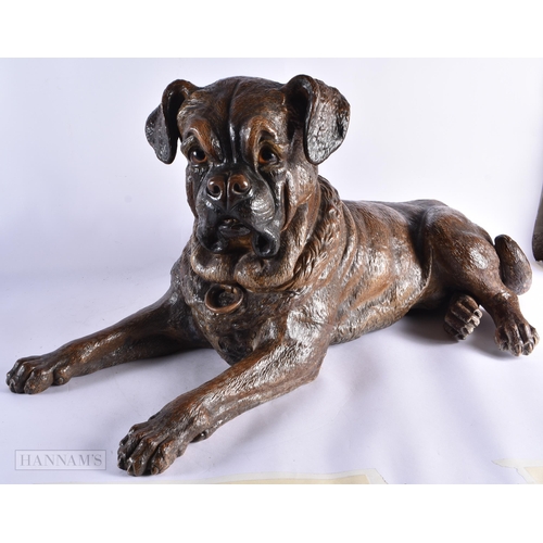 716 - A FINE AND RARE 19TH CENTURY AUSTRIAN COLD PAINTED TERRACOTTA DOG modelled recumbant with glass eyes... 